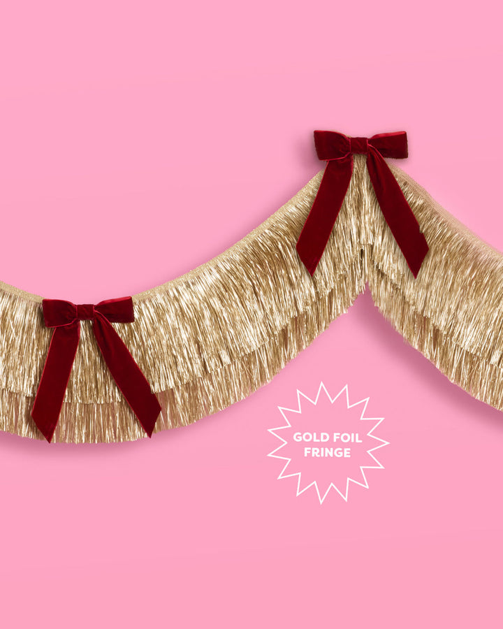 Gold Fringe Backdrop with Burgundy Velvet Bows