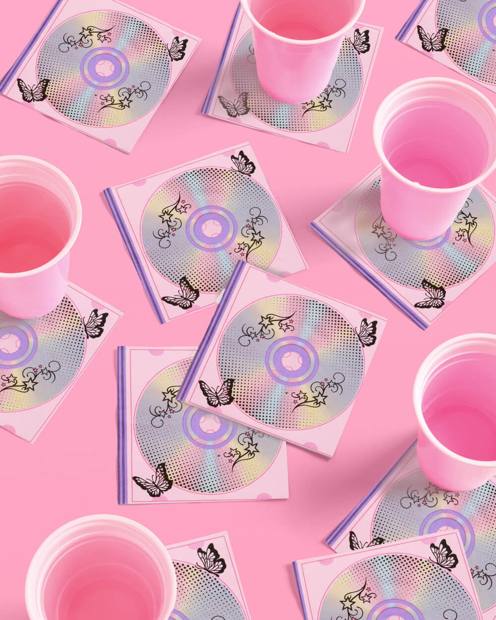 Y2K CD print napkins with pink cups on a pink table