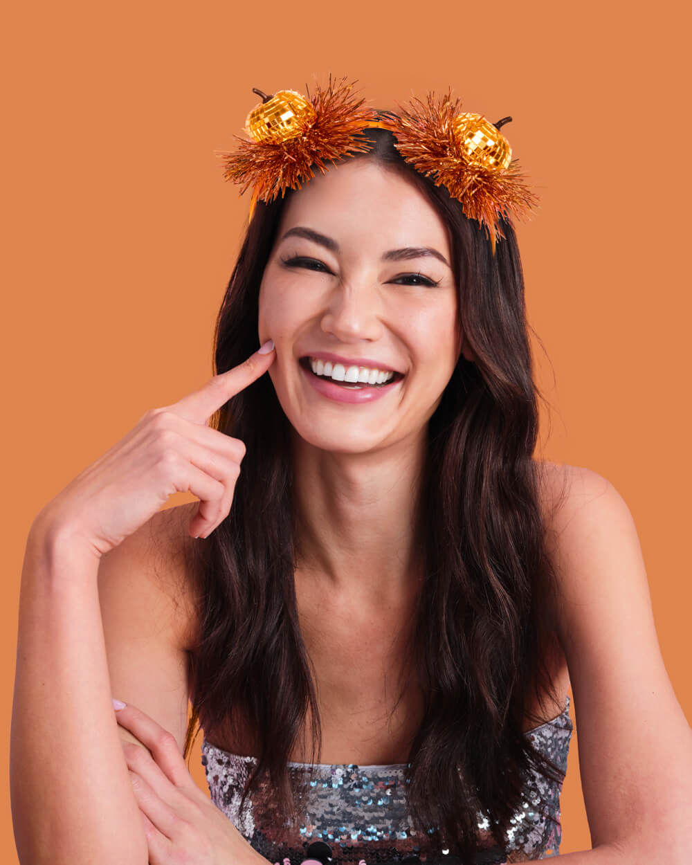 Smiling woman wearing the disco pumpkin fringe headband
