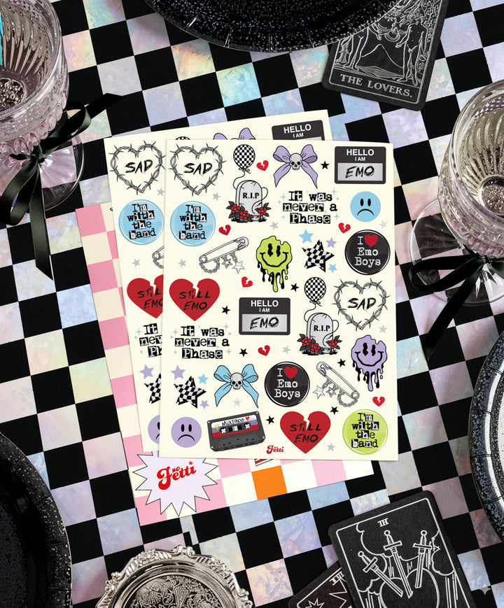 Sheet of emo foil temporary tattoos on a black and white checkered table with silver party plates