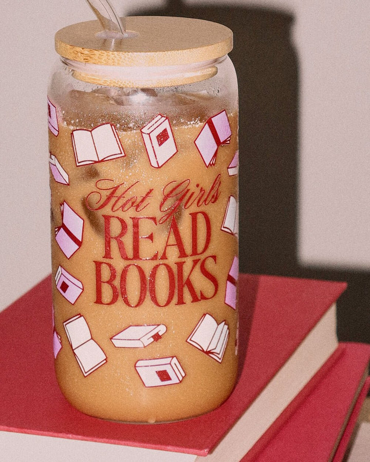 Hot Girls Read Books tumbler of iced coffee resting on a stack of red hardcover books