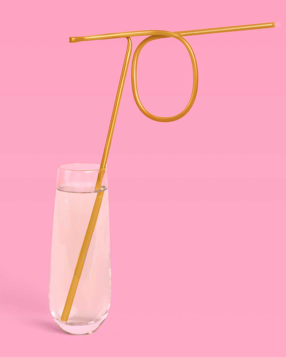 Gold 70 number straw standing in a glass of sparkling wine