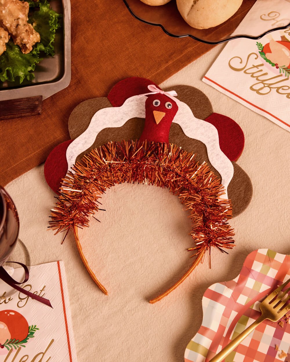 Felt turkey Thanksgiving headband with burgundy, cream, and tan feathers