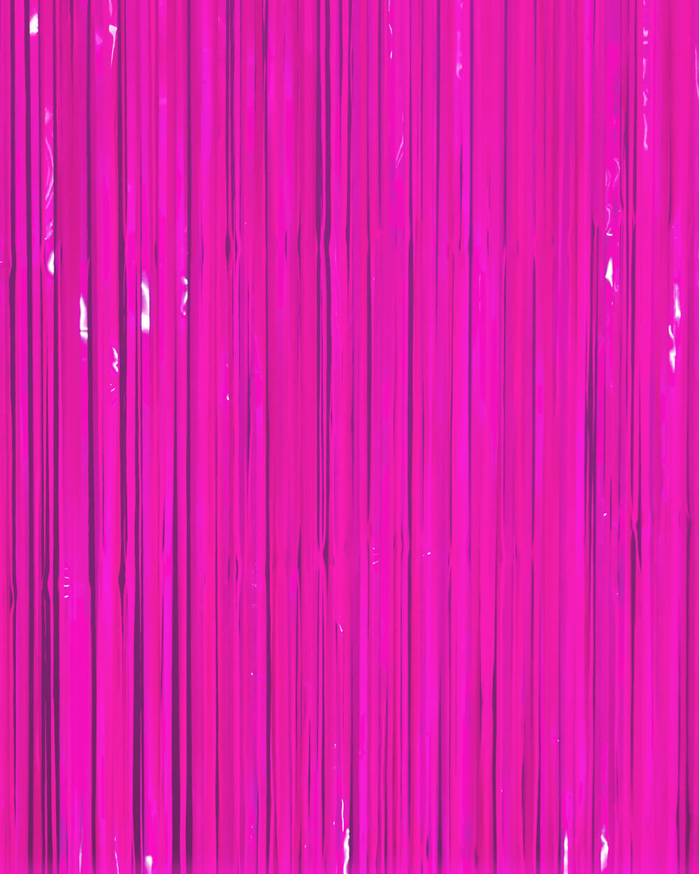 Neon magenta fringe curtain strands hung full width as a glow party backdrop