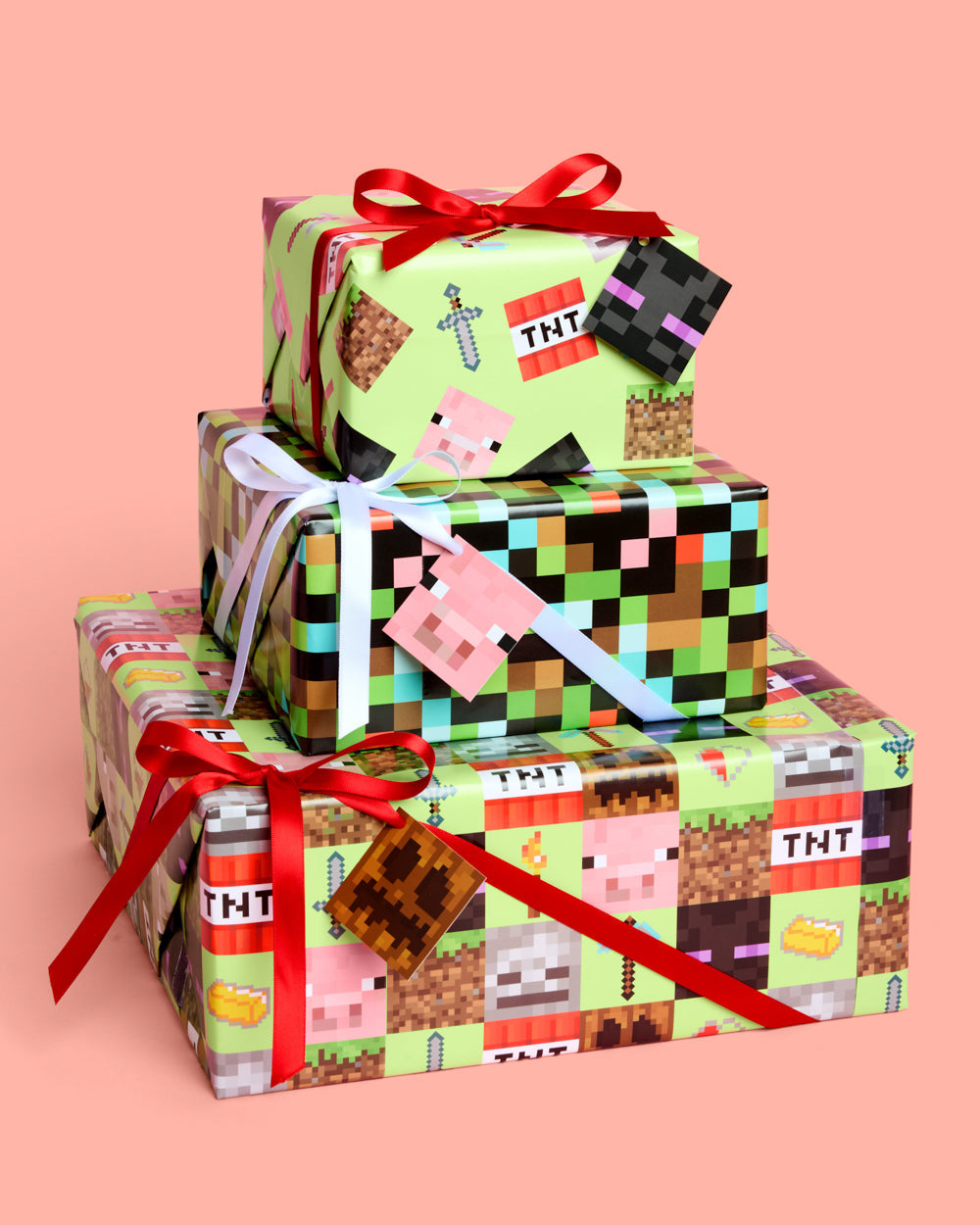 Gifts wrapped in green and black pixel block paper with mining and crafting icons, tied with red and white ribbon.