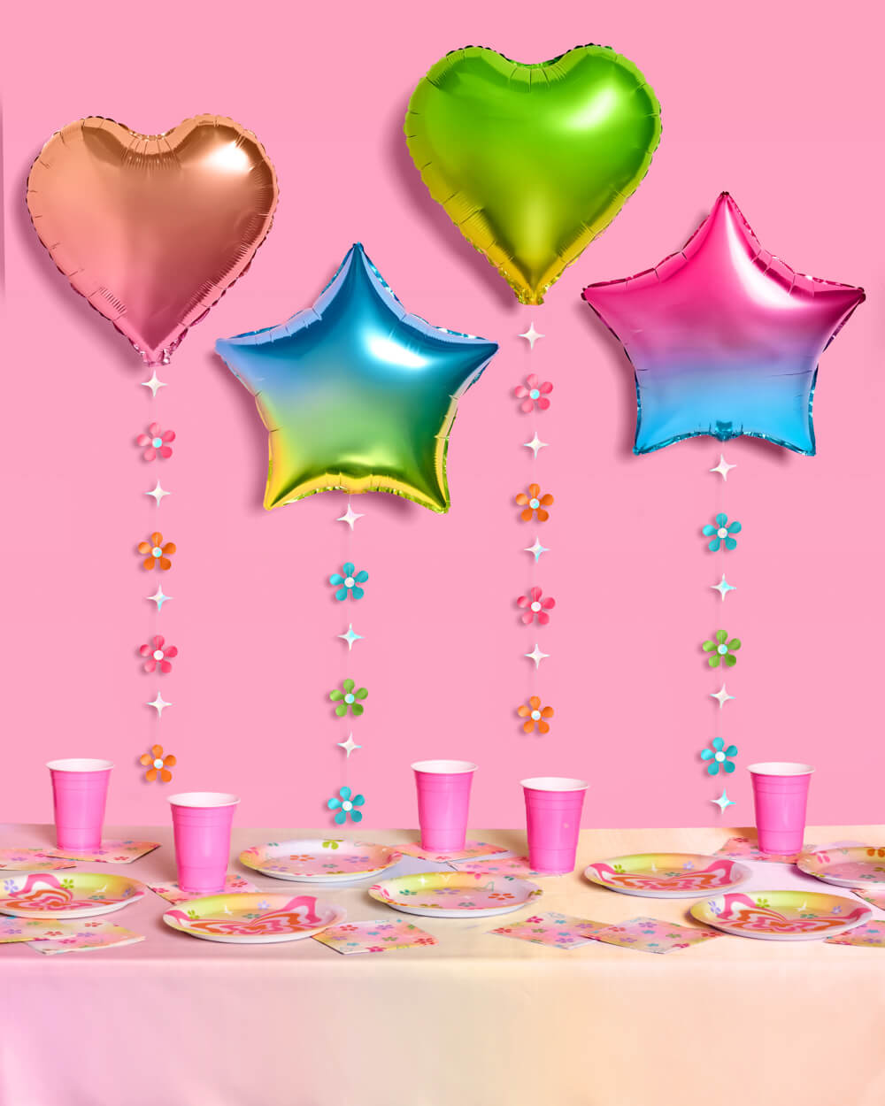 Rainbow foil star and heart balloons styled together