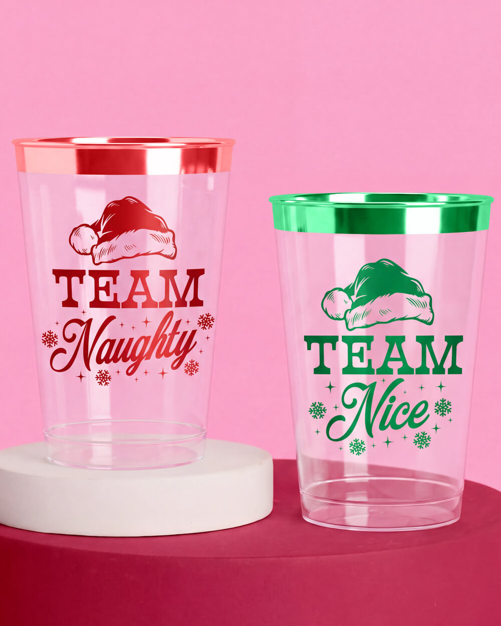 Team Naughty plastic cup with a red foil rim and Team Nice cup with a green foil rim on a red and white stand