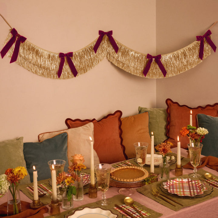 Gold Fringe Backdrop with Burgundy Velvet Bows