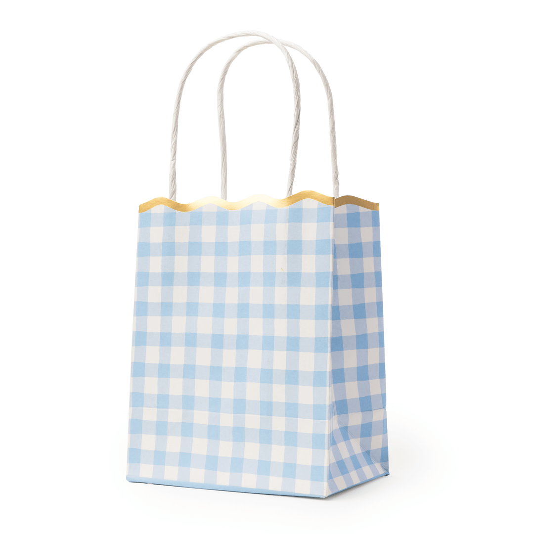 Stack of sky blue gingham favor bags showing the checked pattern and scalloped edge