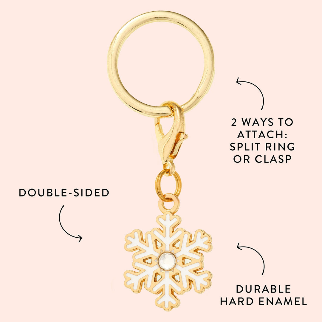 Snowflake charm callout on blush showing the white enamel, gold outline, and split ring or clasp