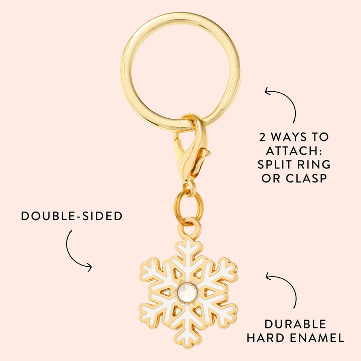 Snowflake charm callout on blush showing the white enamel, gold outline, and split ring or clasp