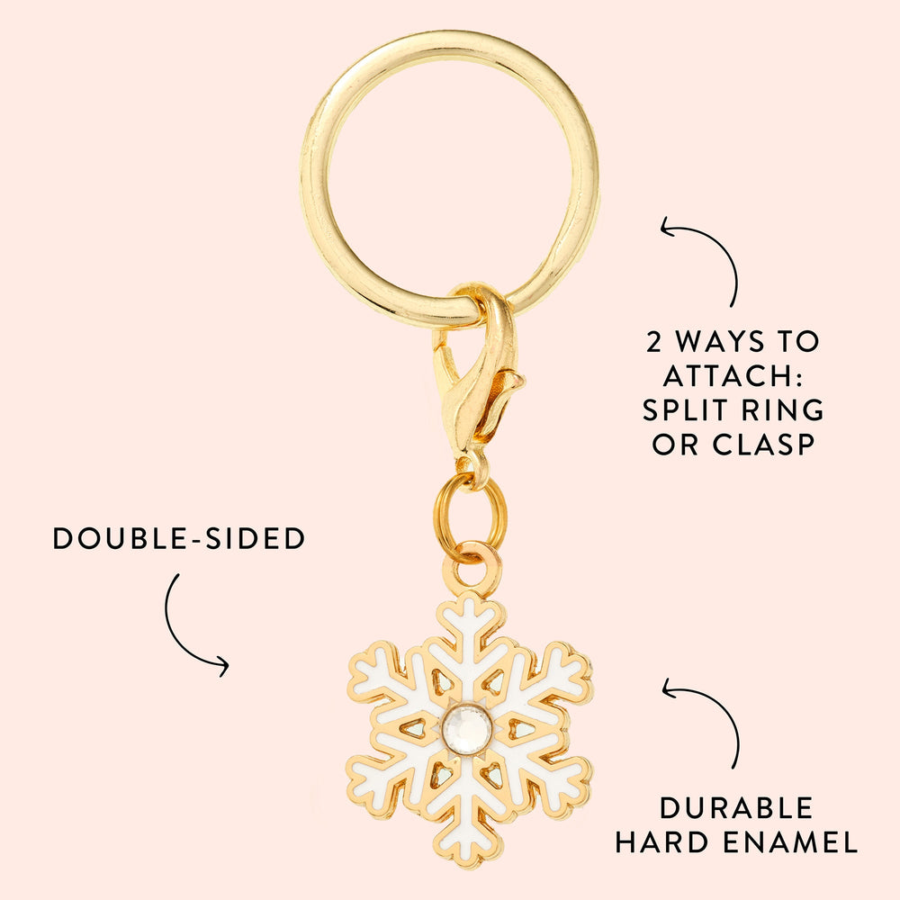 Snowflake charm callout on blush noting double-sided design, durable hard enamel, and two attachments