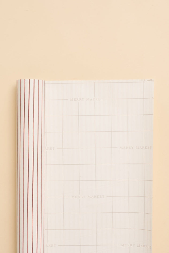 Back of the pinstripe wrapping paper roll showing printed grid lines for measuring