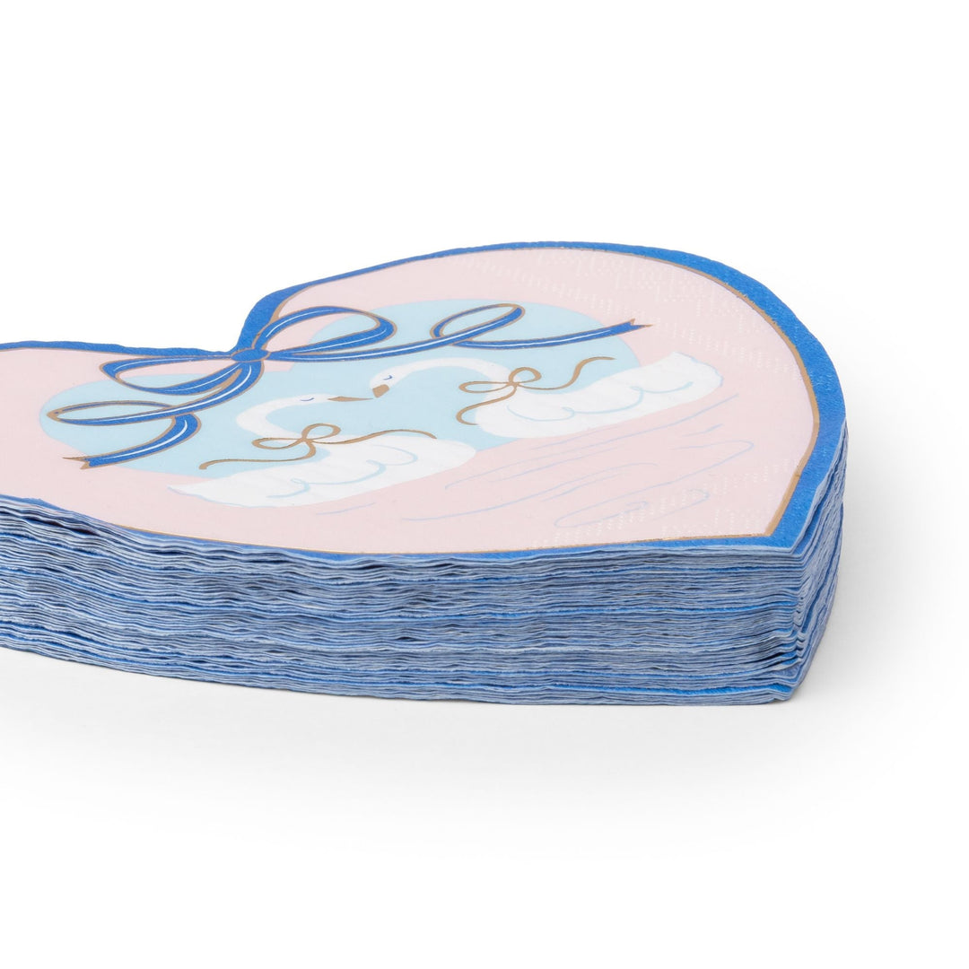 Stack of heart-shaped swan napkins showing the layered bow and swan design