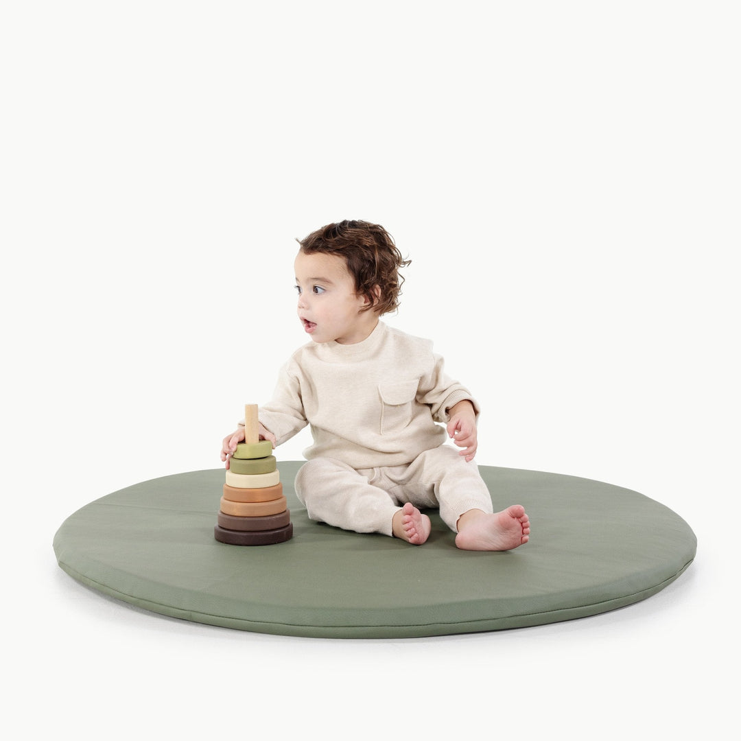 Gathre padded baby play mat in wipeable vegan leather for infant tummy time.