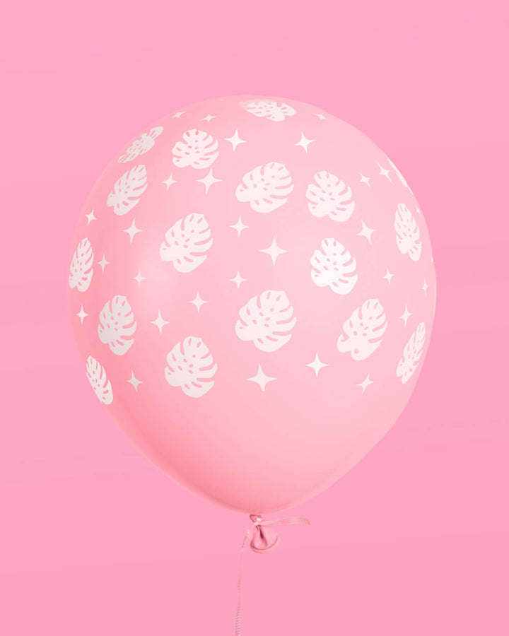 Single white latex balloon with a green palm leaf print