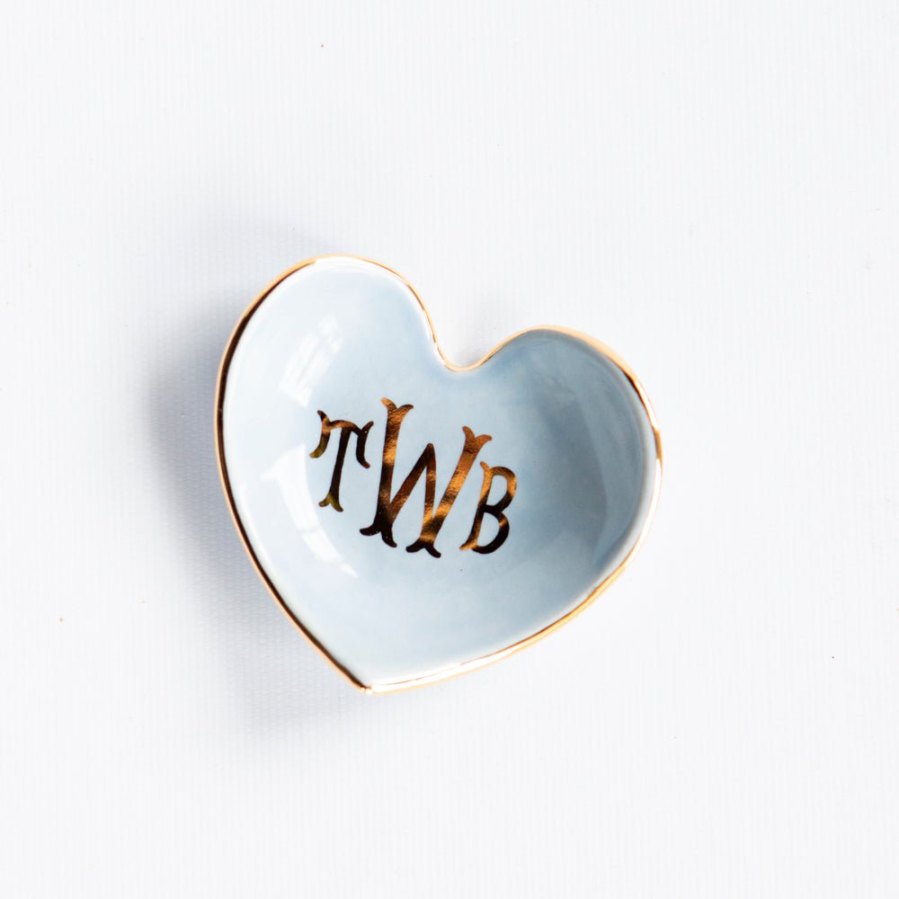 Pale blue heart dish with a gold TWB monogram and gold rim