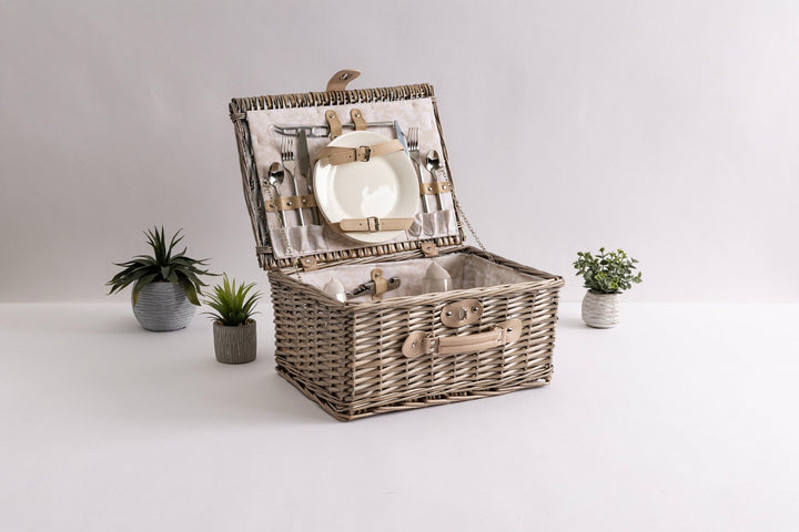 Classic picnic basket for two, carried to a park lunch or a beach evening