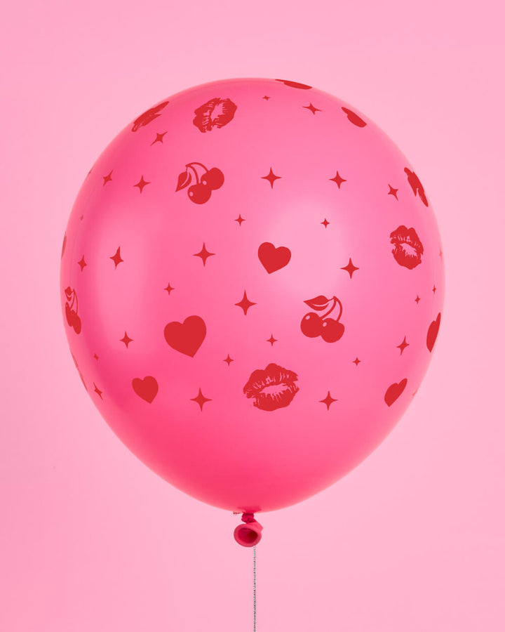 Bunch of Valentine's Day latex balloons against a pink backdrop