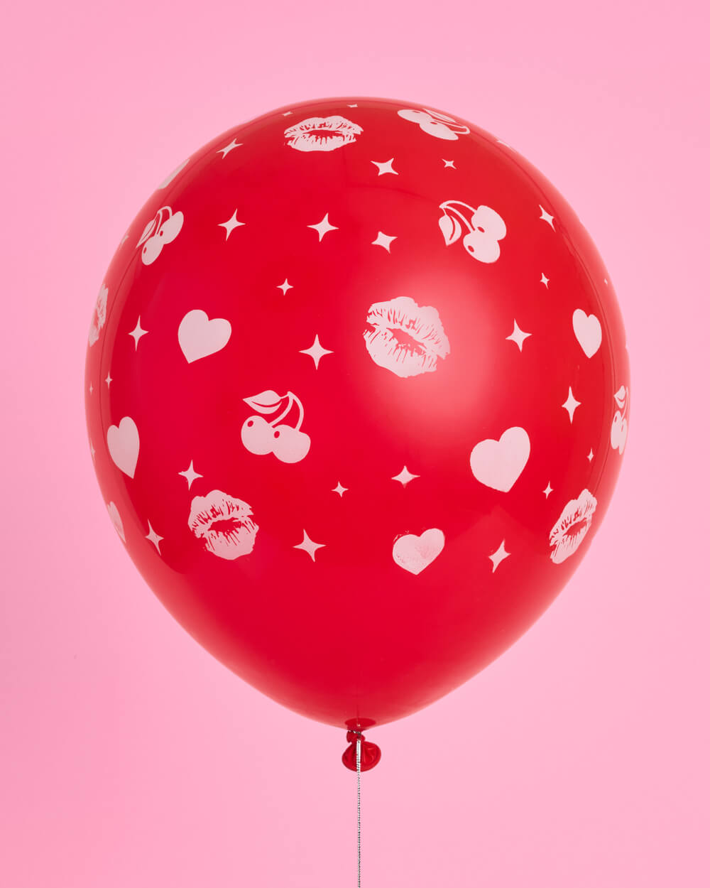 Close-up of red and pink latex balloons with heart and sparkle prints