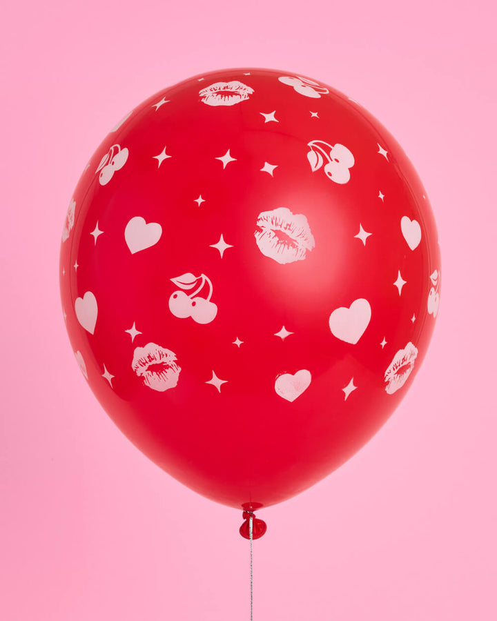 Close-up of red and pink latex balloons with heart and sparkle prints