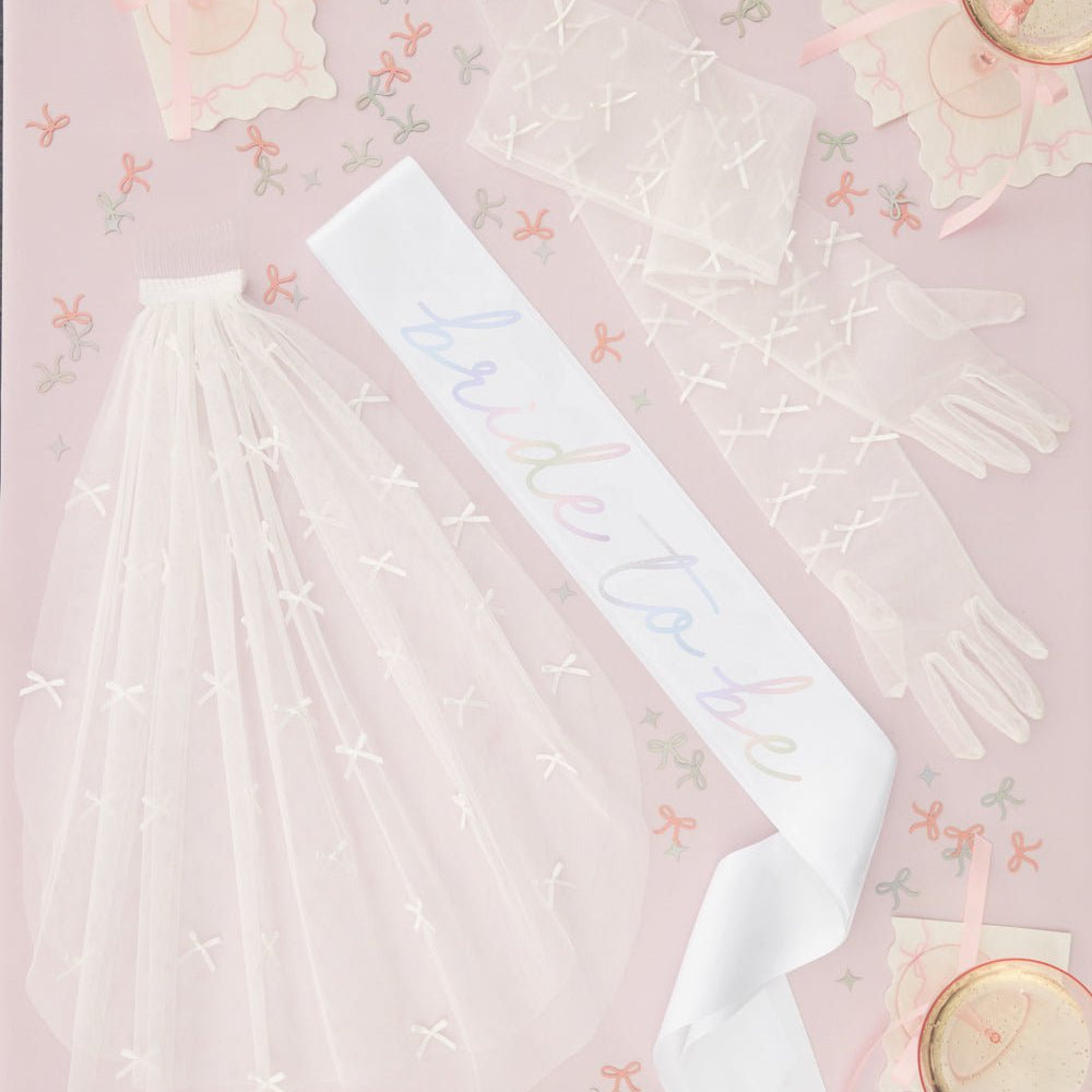 Tying the Knot pack with a bride sash, a veil, and gloves