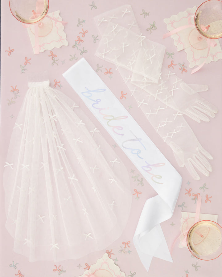 Tying the Knot pack with a bride sash, a veil, and gloves