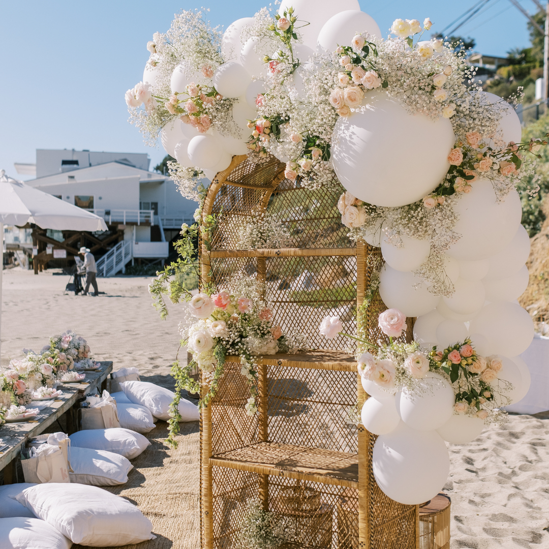 White balloon garland with flower decorations beach party balloon decoration ideas- Los Angeles balloon installation