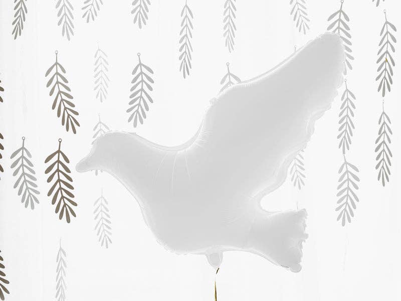 White dove balloon styled against silver willow leaf garlands for a peaceful celebration