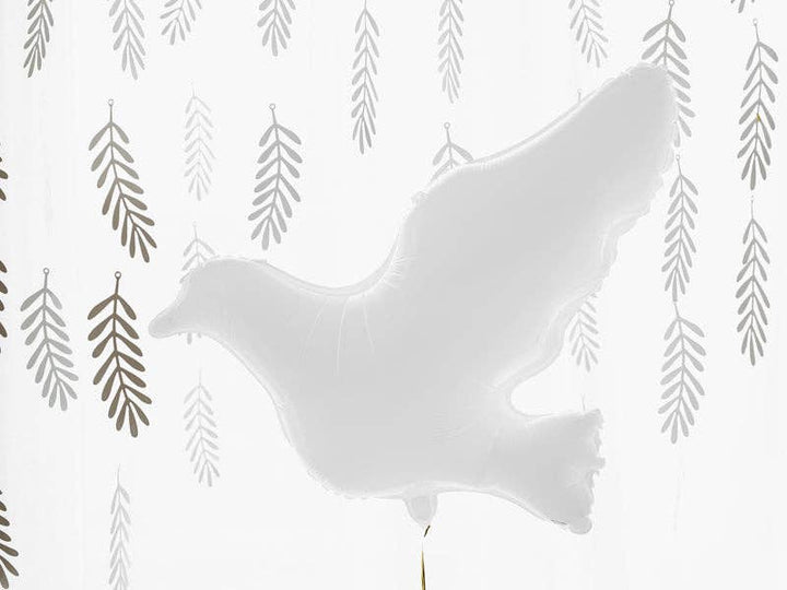White dove balloon styled against silver willow leaf garlands for a peaceful celebration