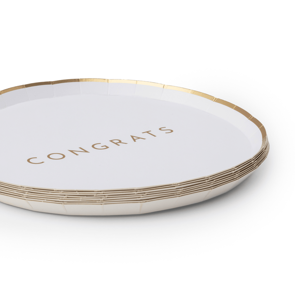 Stack of white and gold Congrats plates showing the gilded rim design