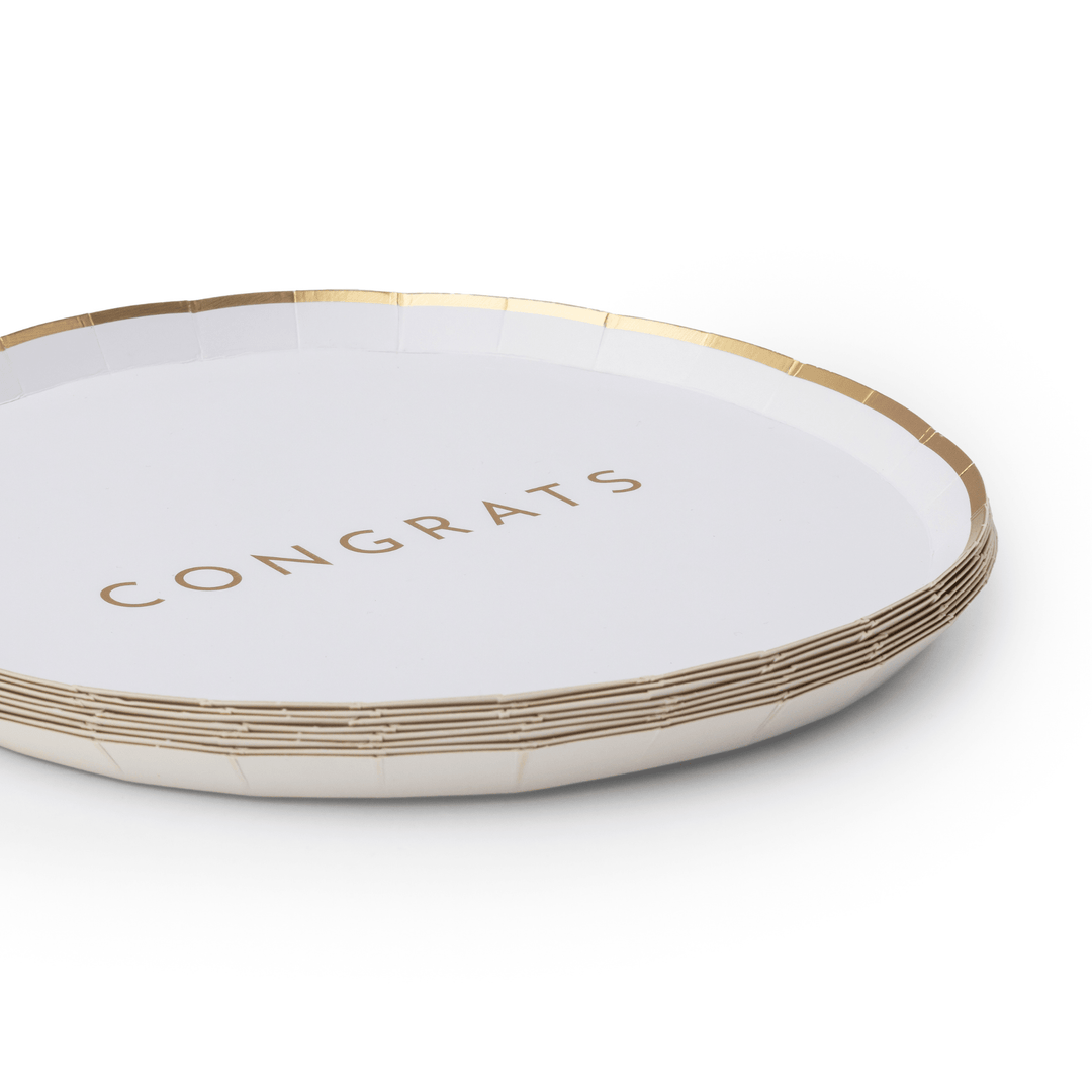 Stack of white and gold Congrats plates showing the gilded rim design