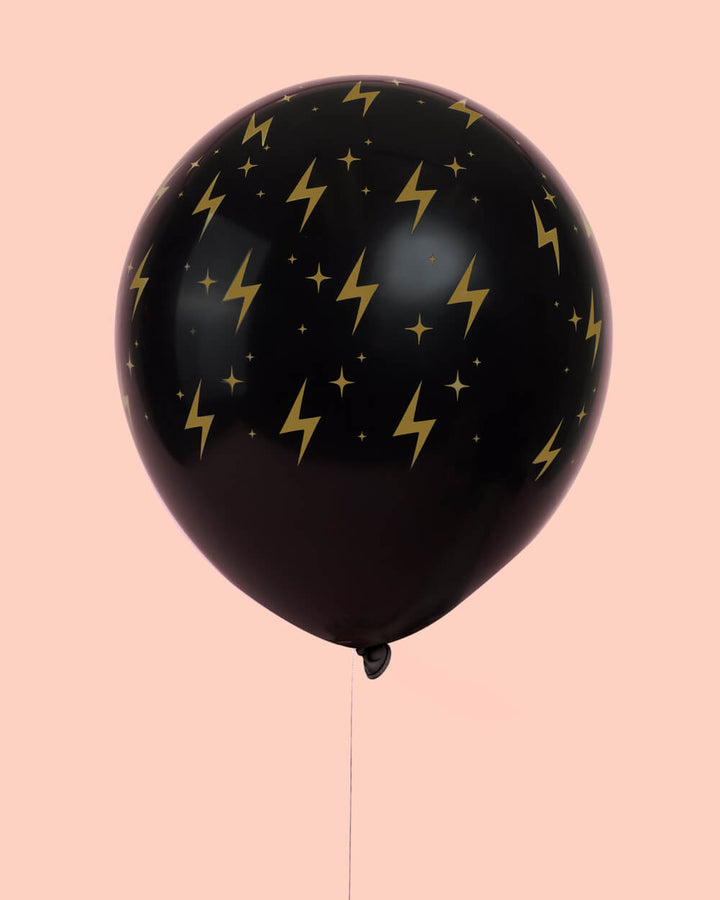 Close-up of a gold wizard latex balloon with a wizard in training print