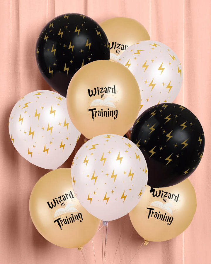 Bunch of wizard latex balloons in black, white, and gold with gold lightning bolts and wizard print