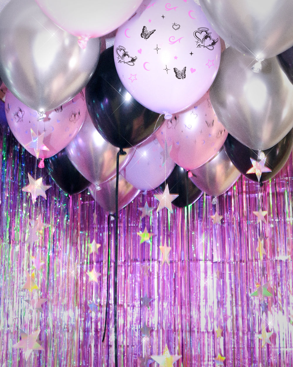 Close-up of Y2K latex balloons with butterfly, heart, and star prints