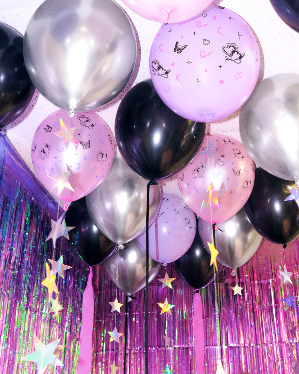 Bunch of Y2K latex balloons in pink, lavender, black, and silver chrome with butterfly prints
