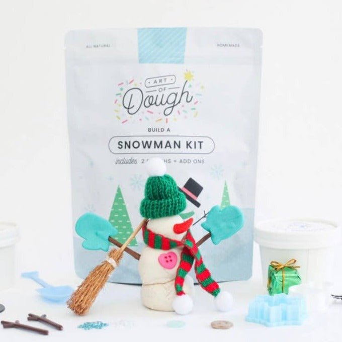 Kids build a snowman kit styled with scented dough, broom, and shovel for holiday play