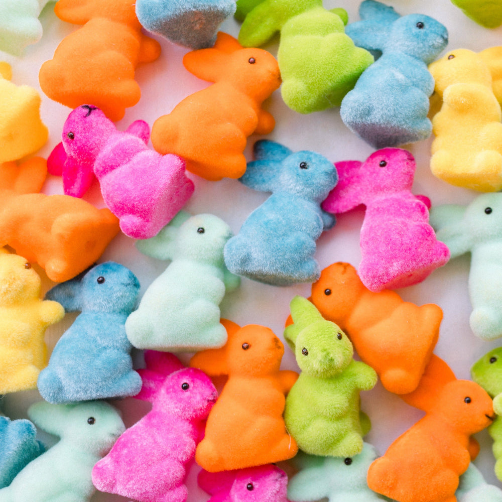 Rainbow flocked bunny decorations, flocked bunnies, and flocked Easter bunnies at Bonjour Fête.